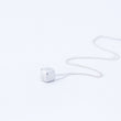 Load image into Gallery viewer, Silver cube necklace - the cube with blunted edges, with chain in a ripple behind