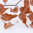 Load image into Gallery viewer, Sterling silver cube, dangles from branch of curled ridged russet leaves