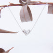 Load image into Gallery viewer, Delicate silver heart with chain and lobster clasp gathered close to it's side
