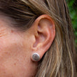 Load image into Gallery viewer, Beach pebble earring set in brushed sterling silver, in left ear of model, part of Found by You Collection