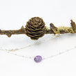 Load image into Gallery viewer, Circlegemstone necklace with silver chain through on a branch with pine cone and moss