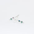 Load image into Gallery viewer, Close up of Eolian earrings, one in front of the other, handmade in sterling silver and emerald and kyanite beads