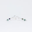 Load image into Gallery viewer, Pair of unusual handcrafted silver stud earrings with beads, next to each other on white background