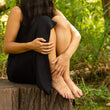 Load image into Gallery viewer, Model on tree stump wearing unique set of handmade silver jewellery: Tailwind bracelet, anklet and ring