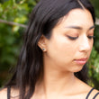 Load image into Gallery viewer, Head and neck shot of Slipstream earrings being worn by model, with trees behind