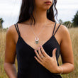 Load image into Gallery viewer, Unusual silver and copper necklace in Spindrift design worn by model in field of long yellow grass