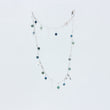Load image into Gallery viewer, Close up of Tailwind anklet from Windblown Collection in a long loop so you can see the emerald and kyanite beads and lengths of silver chain and tiny charms, on a white background