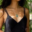 Load image into Gallery viewer, Windcharm necklace from the Windblown Collection with willow trees behind model in V neck black dress