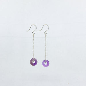 Dangly amethyst gemstones earrings on siver sateliite chain, side view on white background