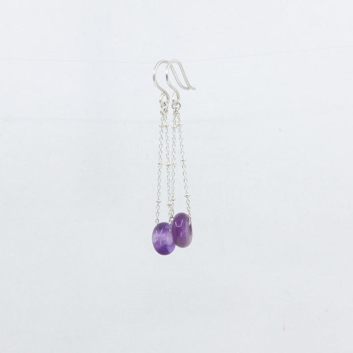 Amethyst gemstones earrings on silver satellite chain, against a white background