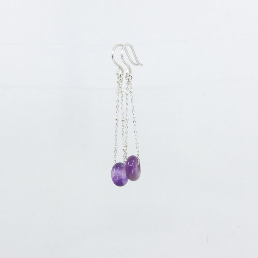 Amethyst gemstones earrings on silver satellite chain, against a white background