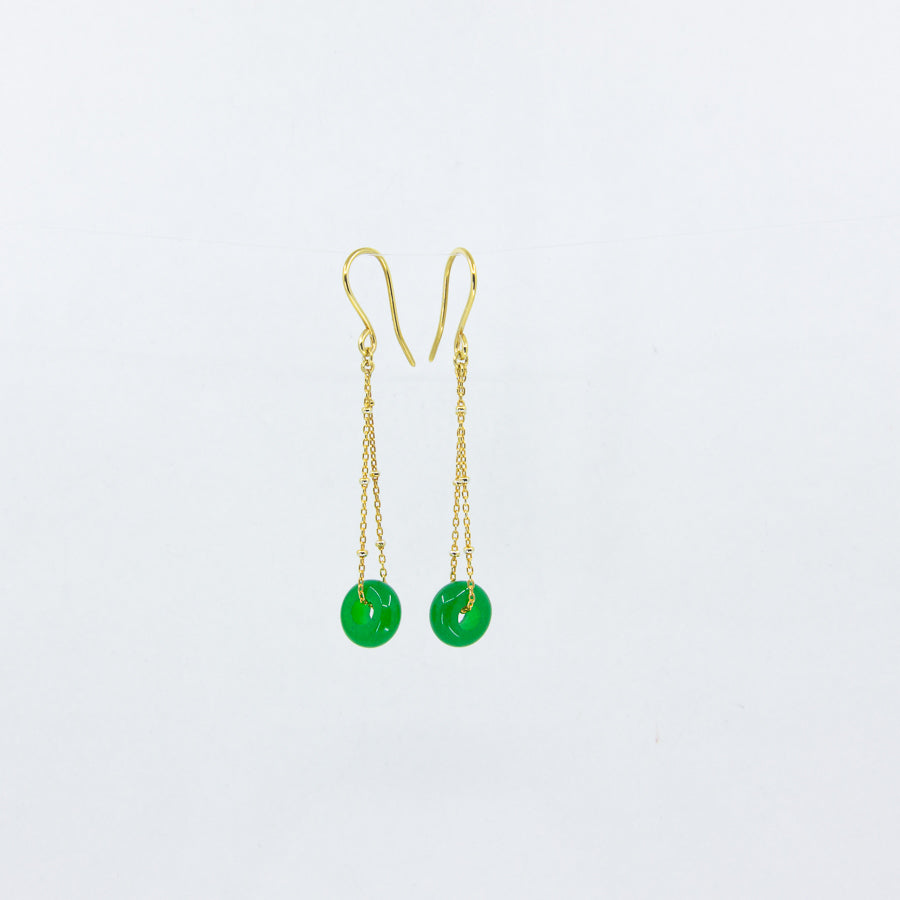 18ct gold-plated dangle earrings with deep green gemstones on a white background