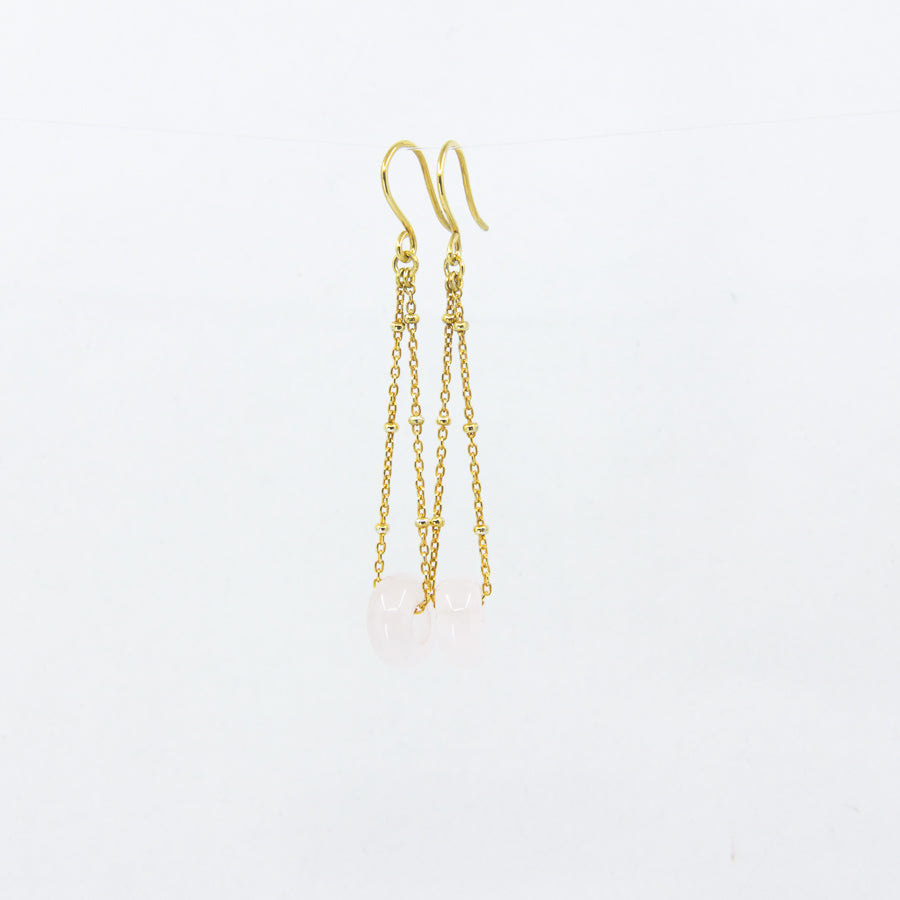 Dangly rose quartz gemstones earrings on 18ct gold-plated sateliite chain, side view on white background