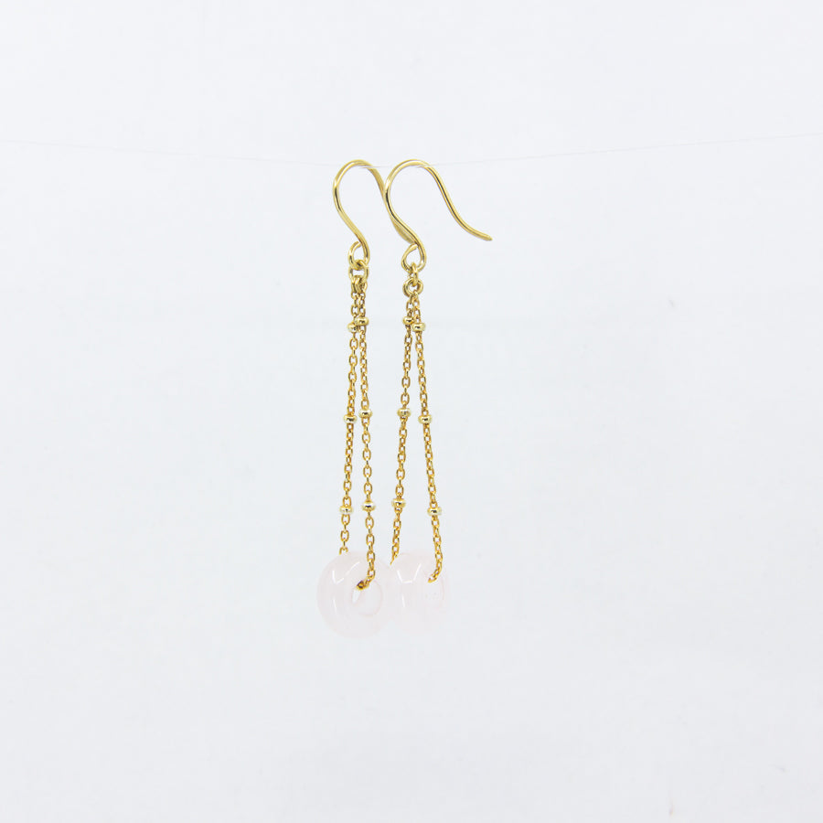 Rose quartz gemstones earrings on gold-plated satellite chain, against a white background