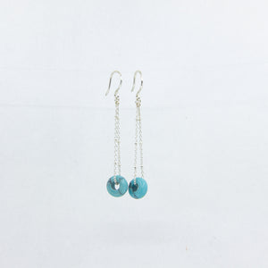 Silver dangle earrings with turquoise gemstones on a white background
