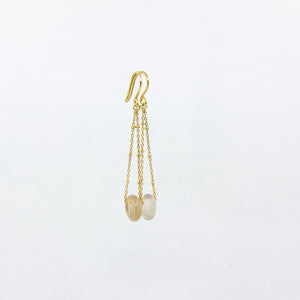 White agate gemstones earrings on gold-plated satellite chain, against a white background