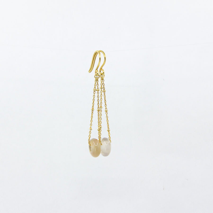 White agate gemstones earrings on gold-plated satellite chain, against a white background
