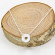 Load image into Gallery viewer, Circle gemstone pendant necklace with silver chain through on a circular wooden block
