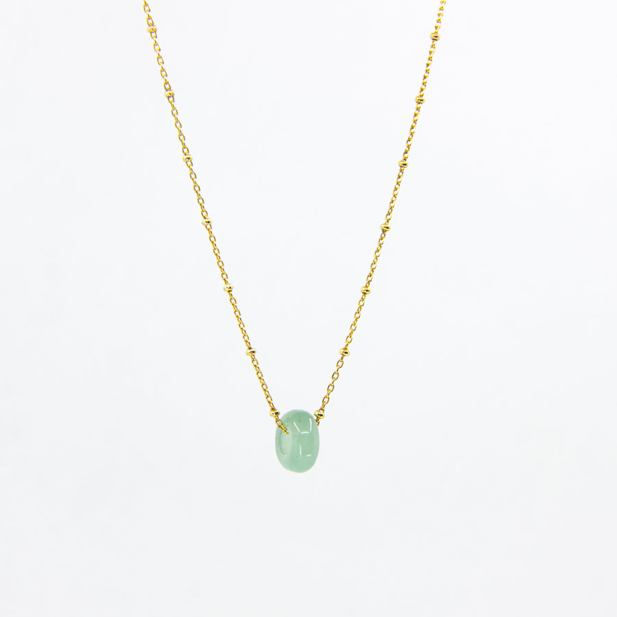 Handmade gemstone necklace with green gemstone and gold-plated satellite chain, on a white background