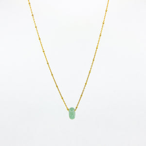 Gold-plated necklace with green aventurine gemstone pendant on white background