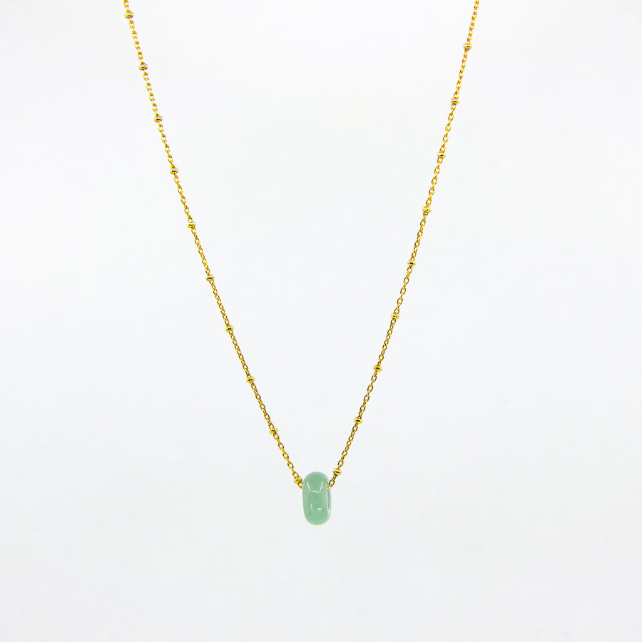 Gold-plated necklace with green aventurine gemstone pendant on white background