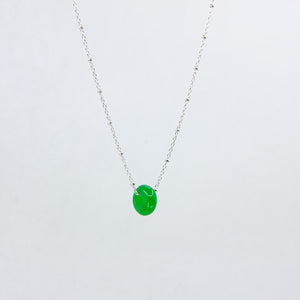 Silver necklace with jade gemstone on white background