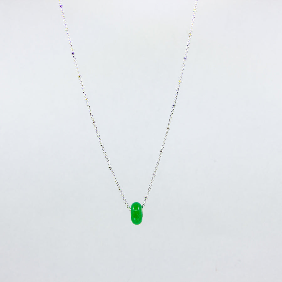 Handmade gemstone necklace with green jade and silver satellite chain, on a white background