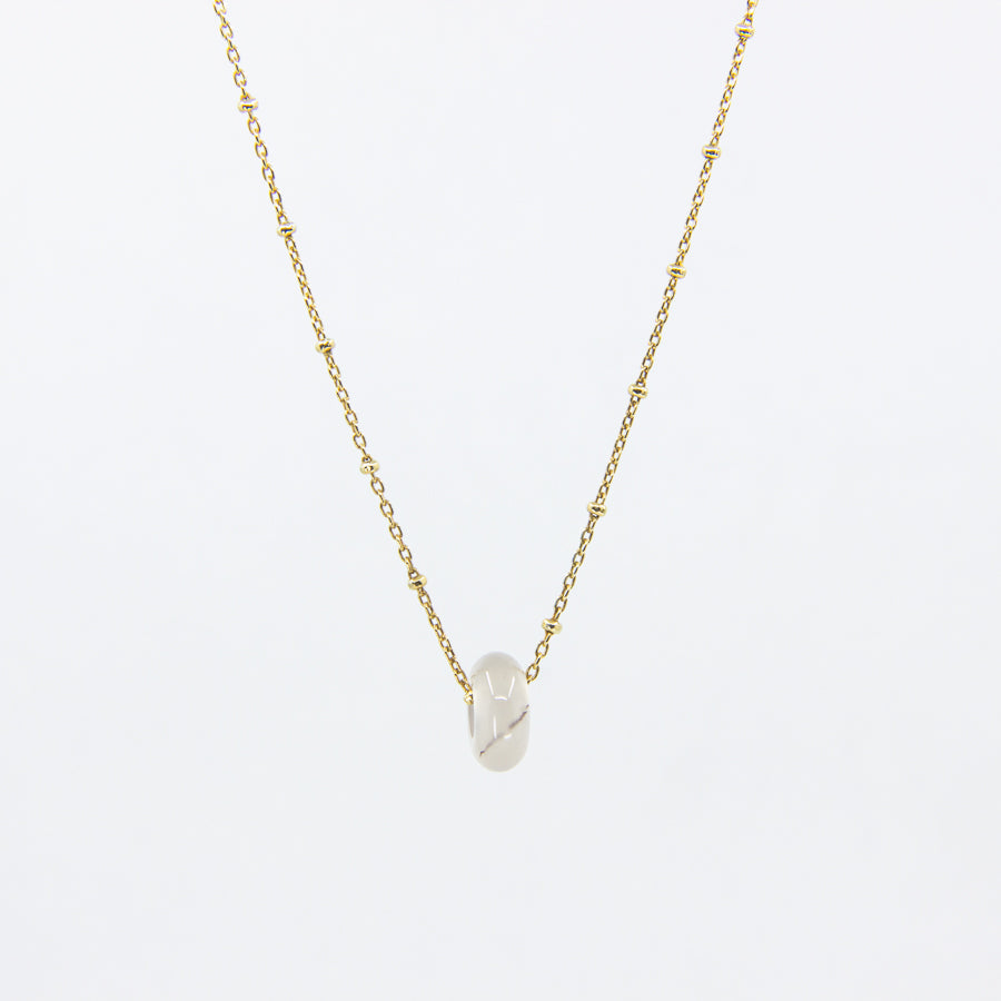 Handmade gemstone necklace with white agate and gold-plated satellite chain, on a white background
