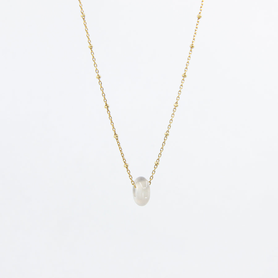 Circle gemstone pendant necklace with gold-plated chain showing clear side of stone