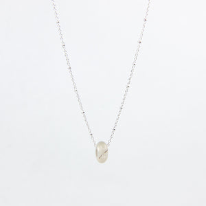 White agate gemstone and sterling silver necklace on white background
