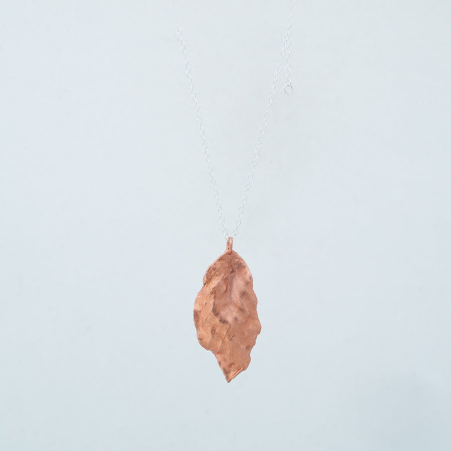 Back view of dangling waving copper leaf