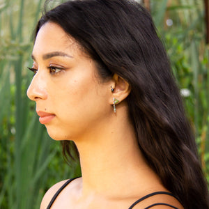 Unusual handmade earrings worn by model, showing Eolian design in her left ear lobe