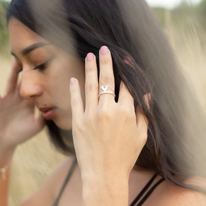 Tailwind made to order silver ring, on a model's hand in close up as she moves her dark long hair