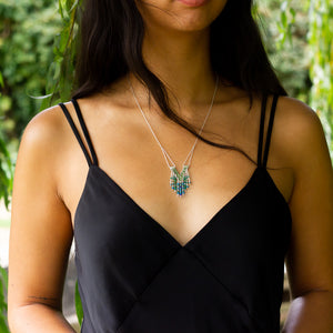 Unique handmade silver and bead necklace, Windcharm design worn by model as her hair blows across her neck