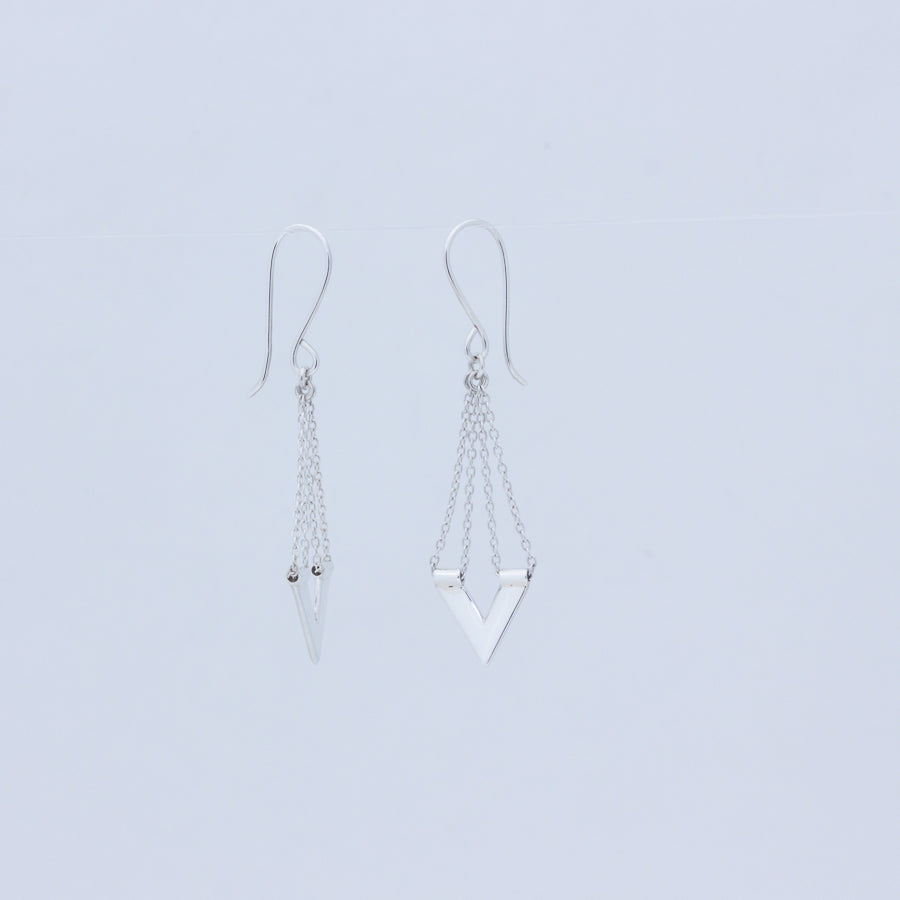 Zephyr silver earrings, one facing forward the other to the side to show profile