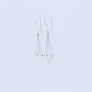 Zephyr earrings sideways view showing chain threaded through tiny tube on top of the V, on white background