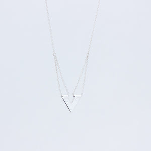 Close up of sterling silver handmade pendant Zephyr necklace, on white background 